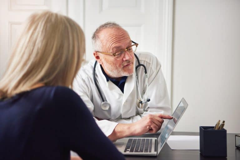 Woman having consultation with doctor at laptop